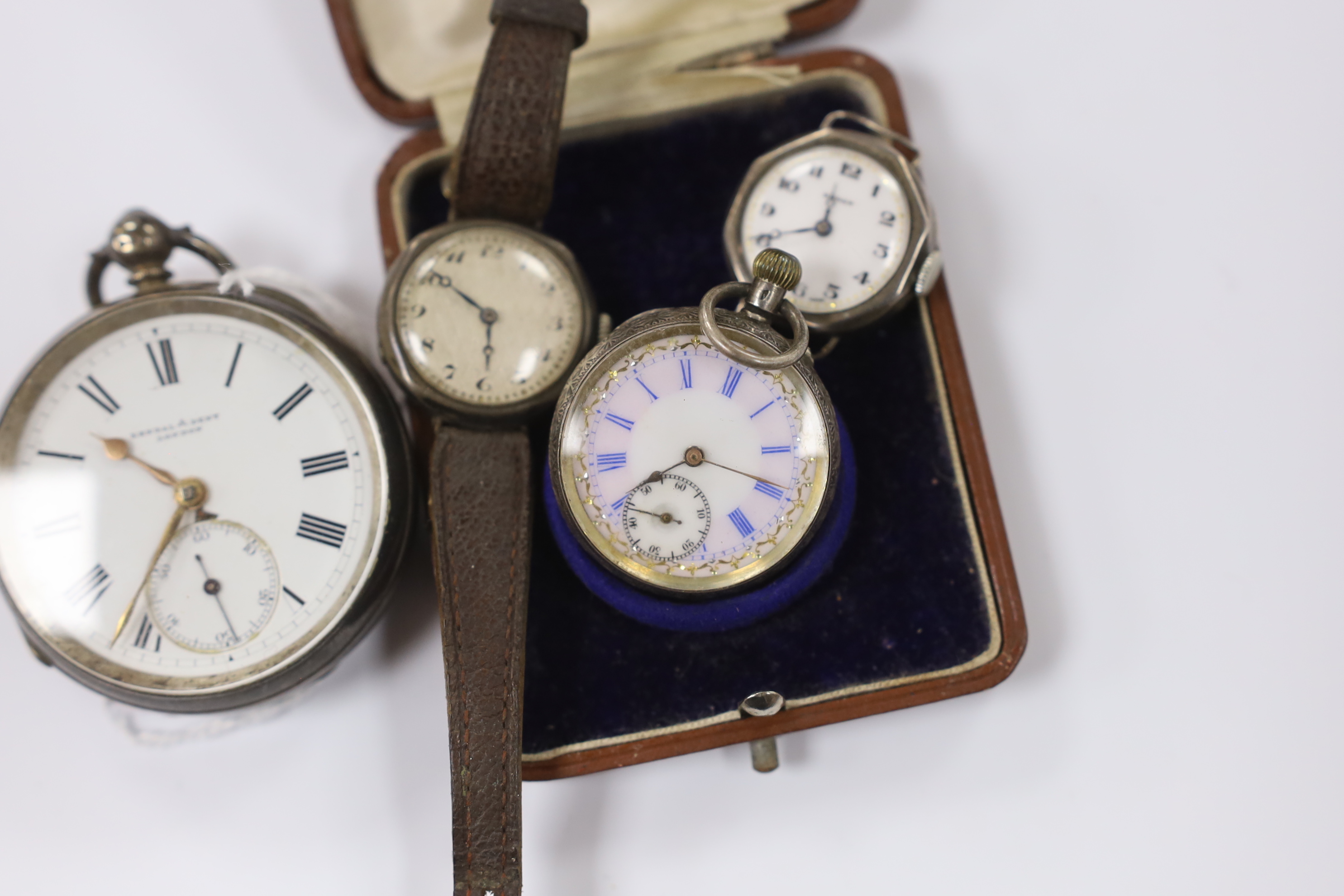 A late Victorian silver open face pocket watch, retailed by Kendall & Dent, a cased Swiss 935 standard white metal fob watch and two silver manual wind wrist watches.